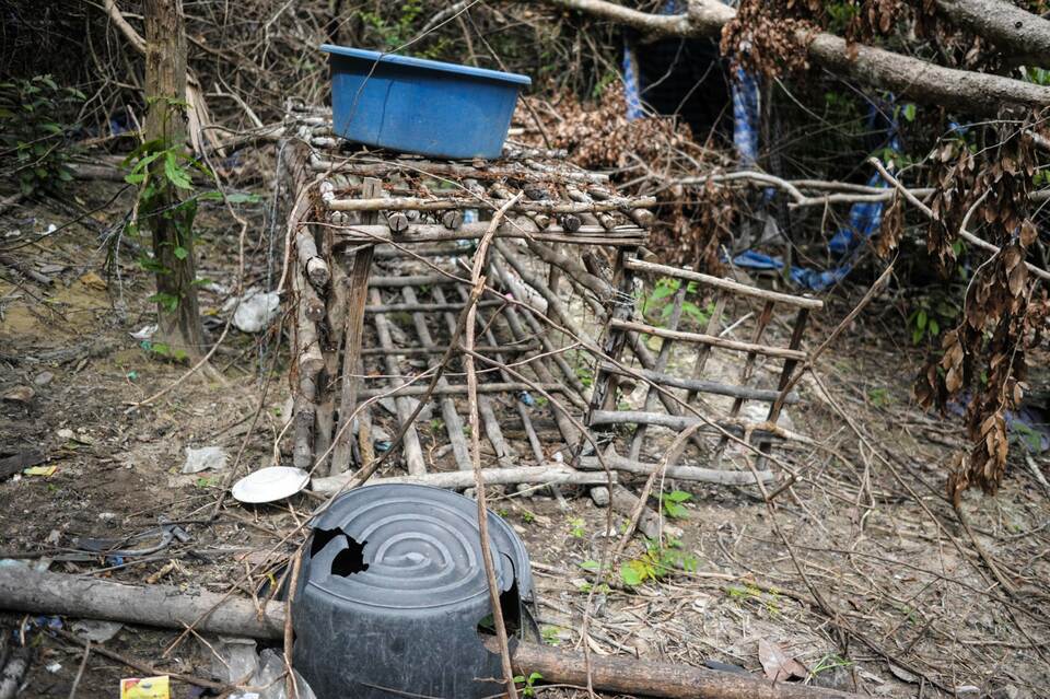 A small cage is seen at an abandoned migrant camp used by people-smugglers in a jungle at Bukit Wang Burma in Malaysia. (AFP Photo/Mohd Rasfan)