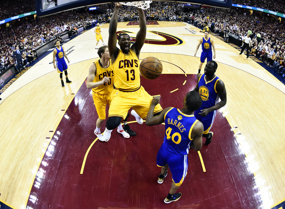 Cleveland Cavaliers center Tristan Thompson (13) dunks the ball over Golden State Warriors forward Harrison Barnes (40) in game three of the NBA Finals. at Quicken Loans Arena. (USA Today Photo/Larry W. Smith)