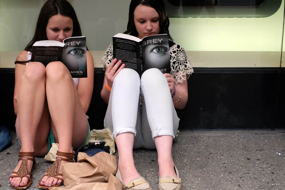 Two fans read their copies of E.L James
