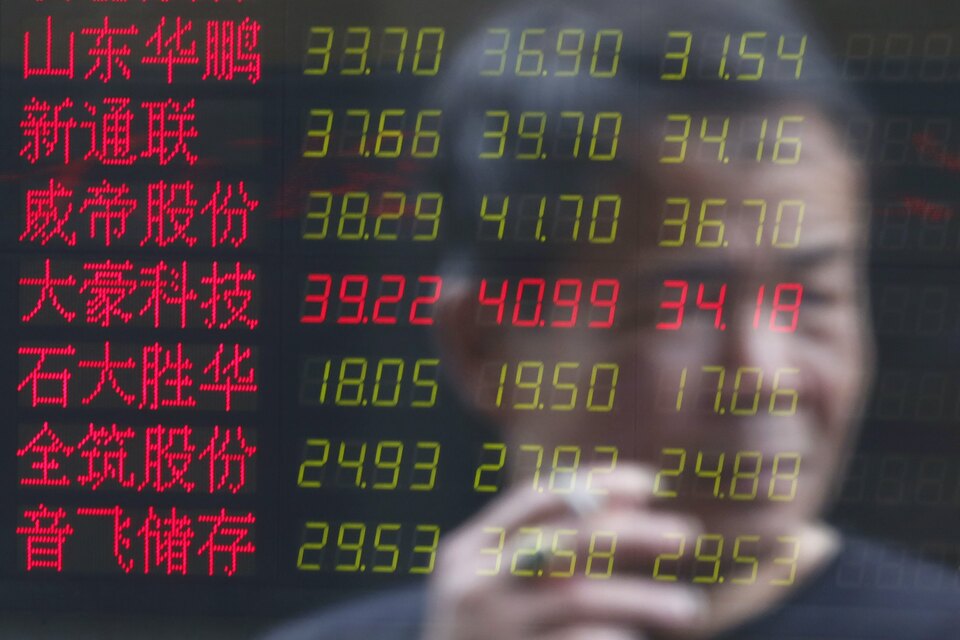 An investor is reflected on an electronic board showing stock information at a brokerage house in Shanghai, China, July 3, 2015. China stocks slumped again on Friday, taking their three-week tumble to nearly 30 percent and wiping out most of this year's gains. (Reuters Photo/Aly Song)