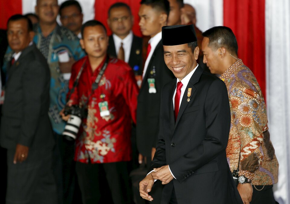 President Joko Widodo smiles as he departs after addressing parliament in Jakarta on Friday. Joko delivered three speeches on the day, deemed a 'historical' move by a supporter. (Reuters Photo/Darren Whiteside)