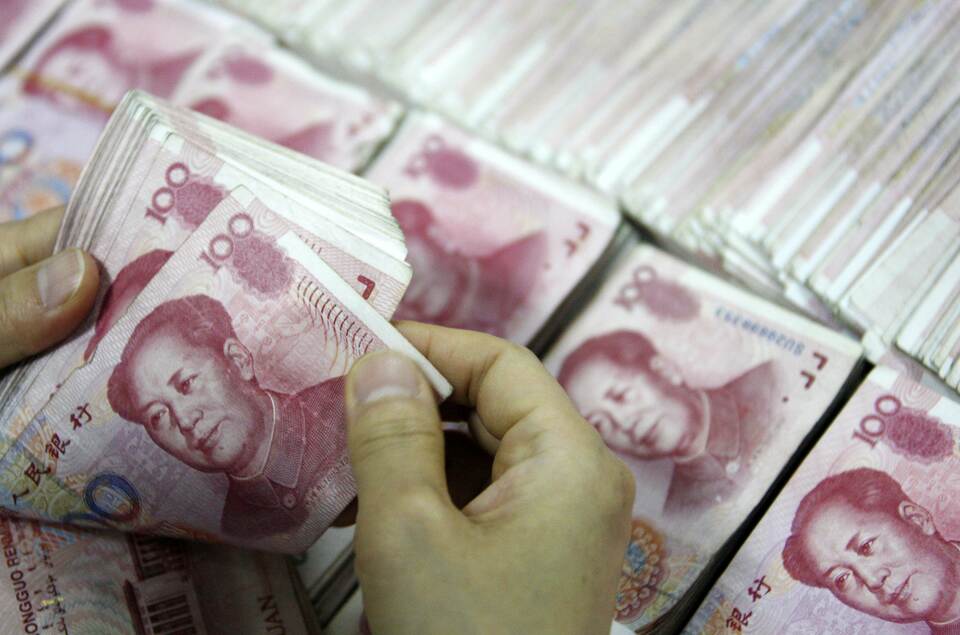 Yuan bank notes being counted. (AFP Photo)