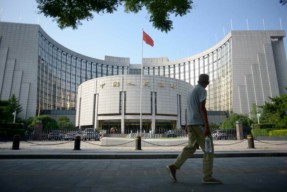 An elderly man walks past the People's Bank of China in Beijing. (AFP Photo/Wang Zhao)