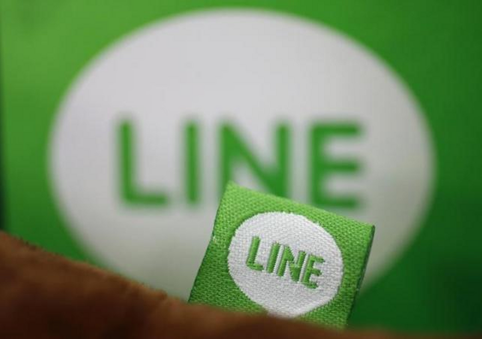The logo of free messaging app Line is pictured on a smartphone and the company's stuffed toy. (Reuters Photo/ Toru Hanai)