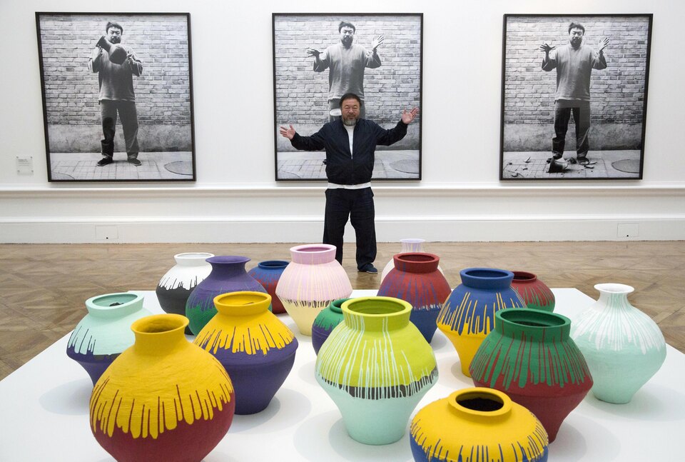 Chinese artist Ai Weiwei poses for photographers in front of his work "Coloured Vases" during a photocall for his exhibition at the Royal Academy of Arts in London, Britain September 15, 2015. The exhibition "Ai Weiwei" runs from September 19 to December 13.  (Reuters Photo/Neil Hall)