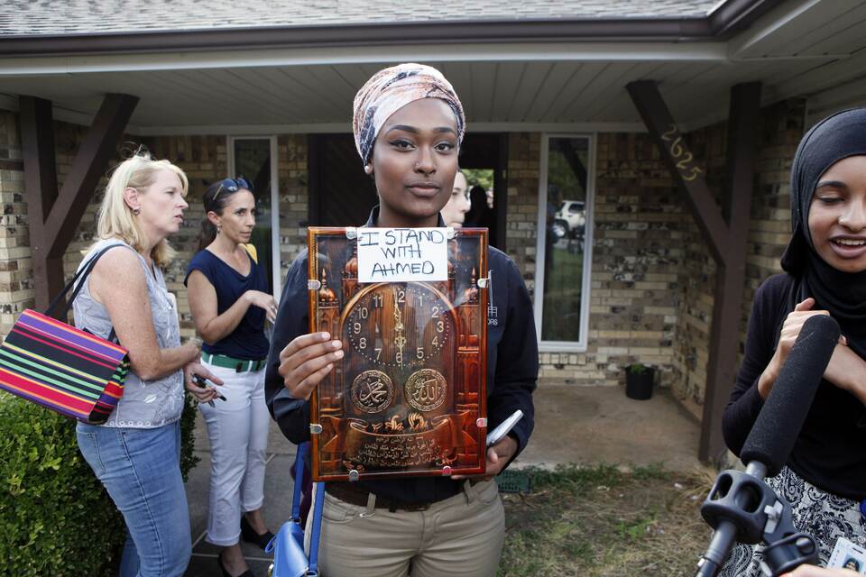 Israa Abdellah, 17, a student at Jack E. Singley Academy in Irving, Texas, holds a sign in support of Ahmed Ahmed Mohammed on September 16, 2015 in Irving, Texas. Mohammed was detained after a high school teacher falsely concluded that a homemade clock he brought to class might be a bomb. (Ben Torres/Getty Images/AFP)