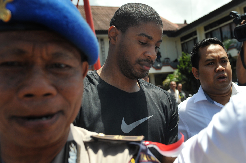 Former Austin police officer Vontrey Jamal Clark is escorted by Bali Police following his arrest in July. (Antara Photo/Nyoman Budhiana) 