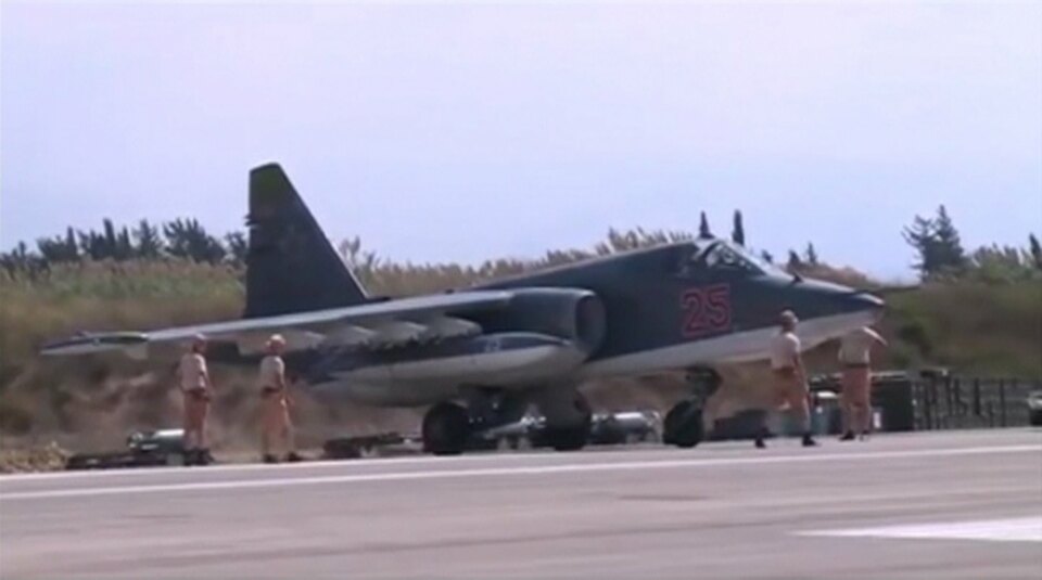 A frame grab taken from footage released by Russia's Defense Ministry on Oct. 5, shows technicians gathering around a Russian Air Force Su-25 military jet on the tarmac of Heymim air base in Syria. (Reuters Photo/Ministry of Defense of the Russian Federation)