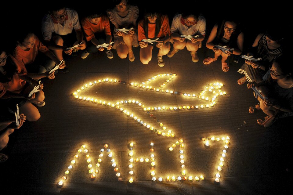 College students gather for a candlelight vigil for victims of the downed Malaysia Airlines Flight MH17 at a university in Yangzhou, Jiangsu province, China in 2014. (Reuters Photo)