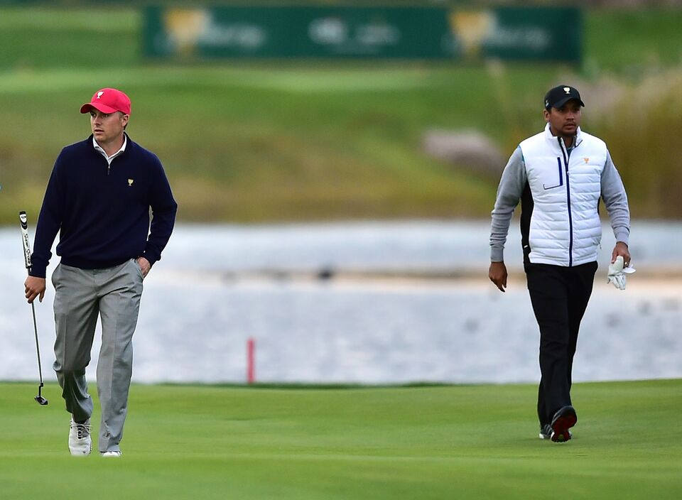Jordan Spieth of the US (L) and Jason Day of Australia (R) walk on the 14th hole during the fourth round of fourball matches of the 2015 Presidents Cup at the Jack Nicklaus Golf Club in Incheon, west of Seoul. (AFP Photo/Jung Yeon-Je)