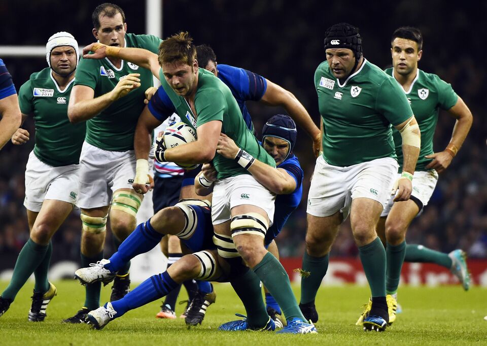 Ireland's center Keith Earls (CL) is tackled by France's lock Bernard Le Roux (CR) during the Pool D match of the 2015 Rugby World Cup between France and Ireland at the Millennium Stadium in Cardiff, south Wales. (AFP Photo/Loic Venance)
