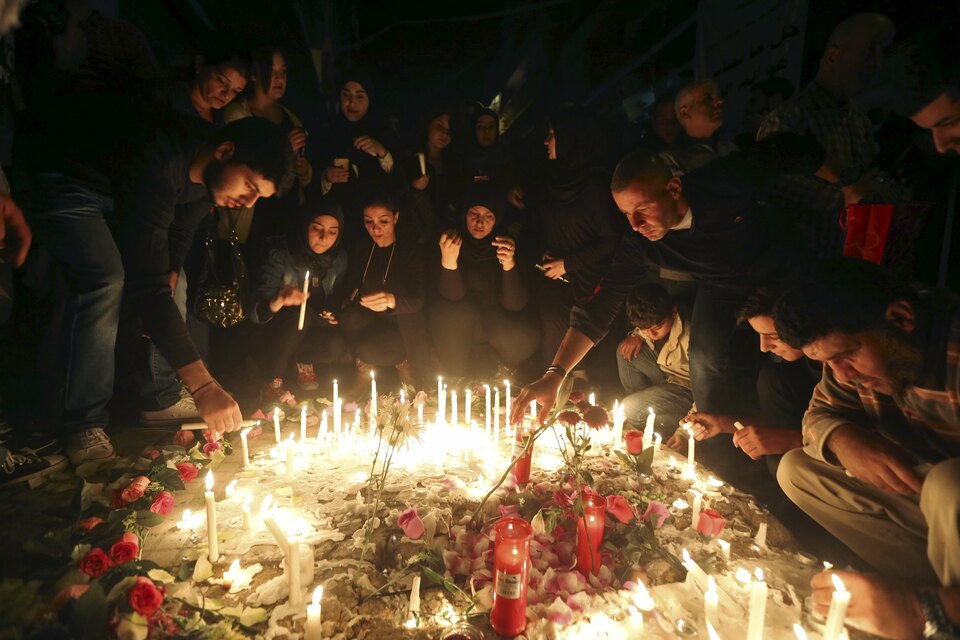 People light candles during a vigil at the site of two explosions that occurred on Nov. 12 in the southern suburbs of the Lebanese capital Beirut. (Reuters Photo/Hasan Shaaban)