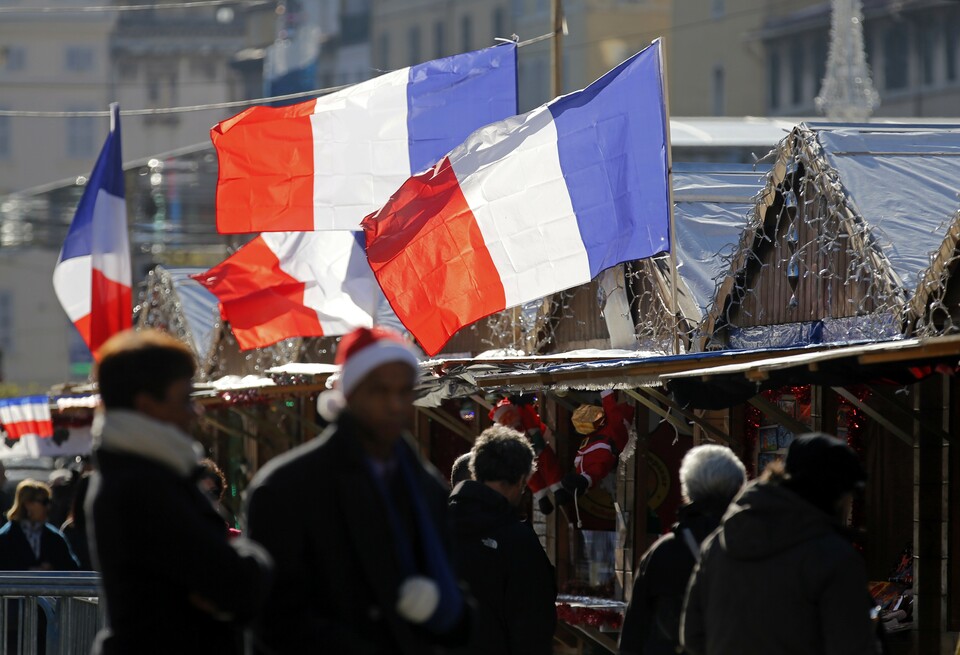 French national flags hang from cabins of the Christmas market in Marseille, France, November 27, 2015 as the French President called on all French citizens to hang the tricolour national flag from their windows on Friday to pay tribute to the victims of the Paris attacks during a national day of homage. (Reuters Photo/Jean-Paul Pelissier)
