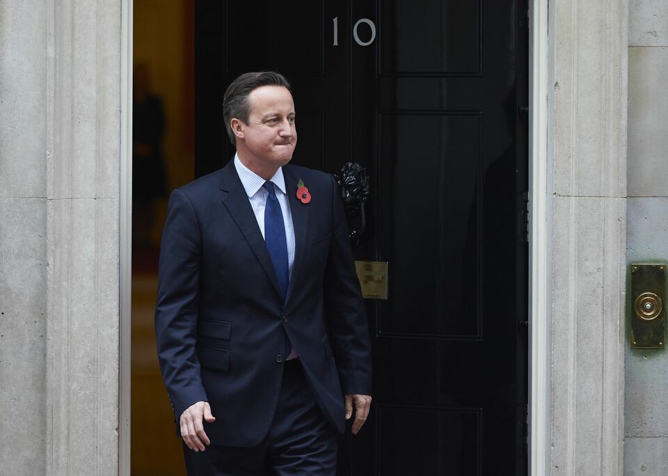 British Prime Minister David Cameron is pictured outside 10 Downing Street in London on November 3, 2015, as he waits to greet President Nursultan Nazarbayev of Kazakhstan. The British government on Tuesday denied it was abandoning plans for a parliamentary vote to join air strikes in Syria as an influential committee of MPs advised against action. Newspaper reports suggested Prime Minister David Cameron had abandoned plans to seek parliamentary approval to extend missions against the Islamic State jihadist group from Iraq into neighbouring Syria. (AFP Photo/Nikklas Halle'n)