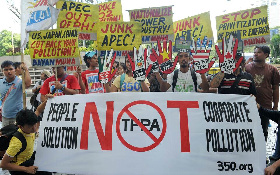 Protesters rally in front of the hotel where the Asia Pacific Economic Cooperation (APEC) Climate Change Symposium is being held in Manila on November 4, 2015. the protesters claim that APEC is missing the point on climate change and its solutions, with the need to cut back on emissions and a radical change of production and consumption patterns. (AFP Photo/Jay Directo)