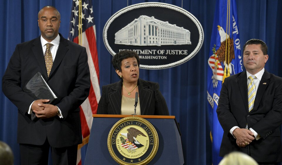 US Attorney General Loretta Lynch, center, makes remarks at a news conference to announce a law enforcement action relating to FIFA. Officials Alfredo Hawit and Juan Angel Napout have been arrested by Swiss authorities in the ongoing football scandal.   (Reuters Photo/Mike Theiler)