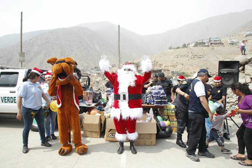 A Peruvian police officer dressed as Santa Claus reacts during Christmas celebration in Huaycan on the outskirts of Lima, Peru December 15, 2015. REUTERS/Janine Costa   EDITORIAL USE ONLY. NO RESALES. NO ARCHIVE