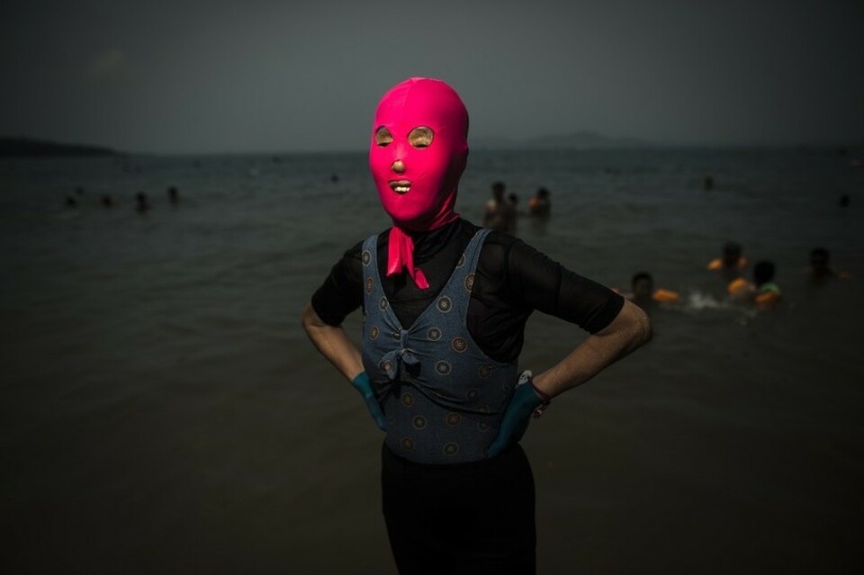 A woman wearing a facekini poses at the beach in Qingdao, eastern China's Shandong province on July 24, 2015. (AFP Photo/Fred Dufour)