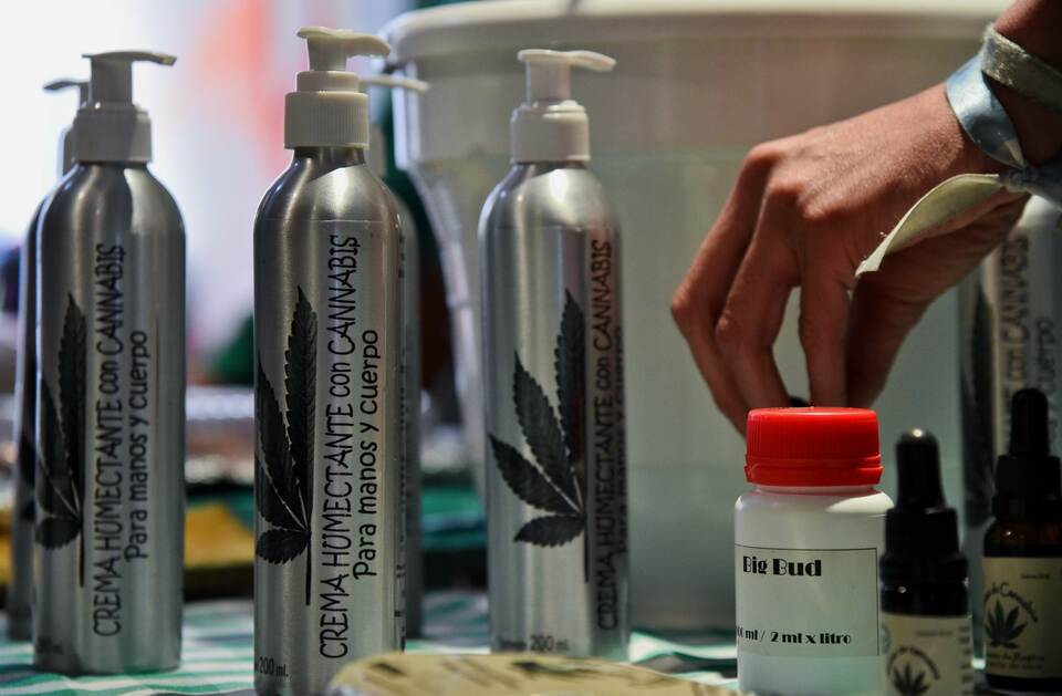 A man displays for sale cannabis-made products for therapeutic use at a fair of products and derivatives of marijuana for medicinal use in Bogota, Colombia, on December 22, 2015. On Tuesday, Colombia legalized medical marijuana through a decree signed by President Juan Manuel Santos, which regulates the cultivation, processing, importation and exportation of cannabis and its derivatives for therapeutic purposes. Colombia thus joins to Mexico, 23 states of US and Uruguay, which have allowed the use of cannabis for medicinal purposes. Chile, meanwhile, is studying a decriminalization in a draft legislation in Congress. (AFP Photo/Guillermo Legaria)