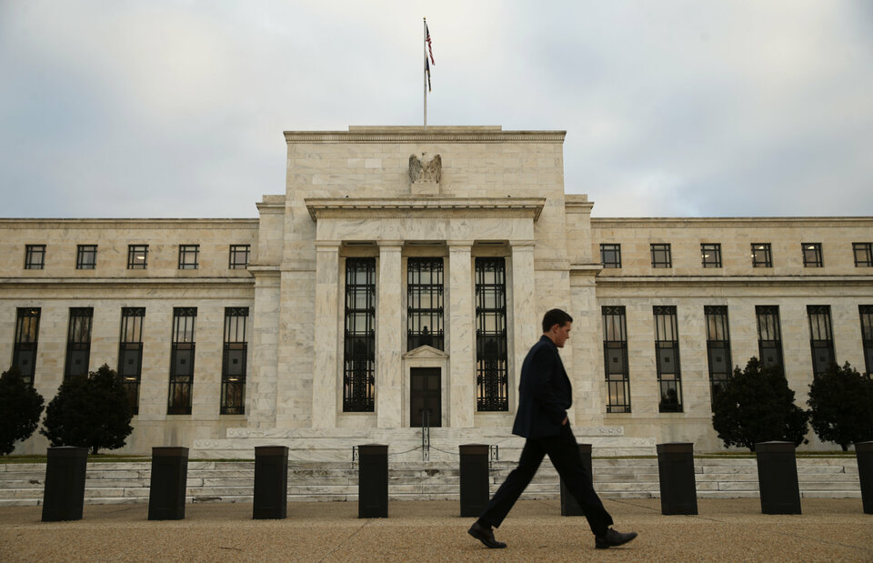 A man walks past the Federal Reserve in Washington. (Reuters Photo/Kevin Lamarque)