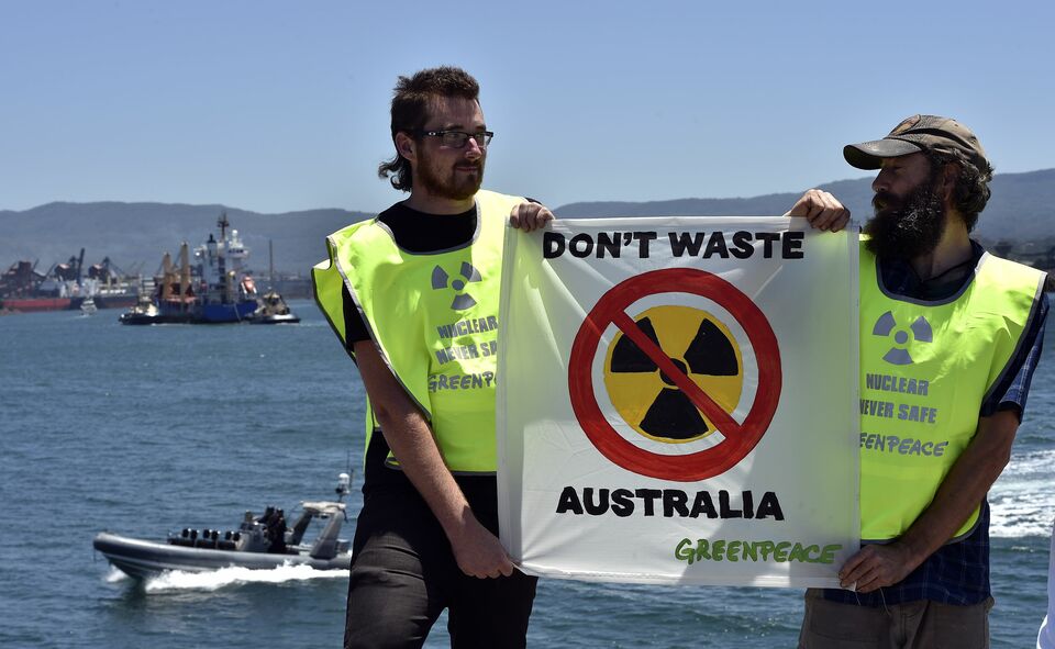 Anti-nuclear protesters in rubber dinghies and water police shadowed a vessel carrying a shipment of reprocessed nuclear waste as it docked on Saturday at an Australian port after a two-month voyage from France. (AFP Photo/Saeed Khan)