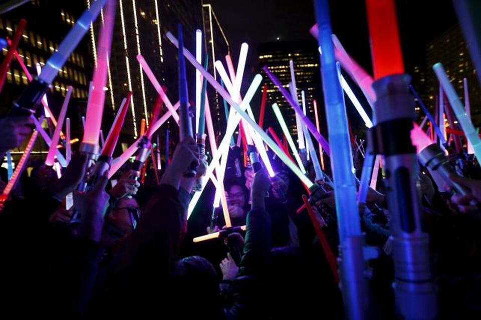 People gather with their lightsabers during a Star Wars-themed lightsaber battle at Sue Bierman Park in San Francisco on Dec. 18. (Reuters Photo/Stephen Lam)