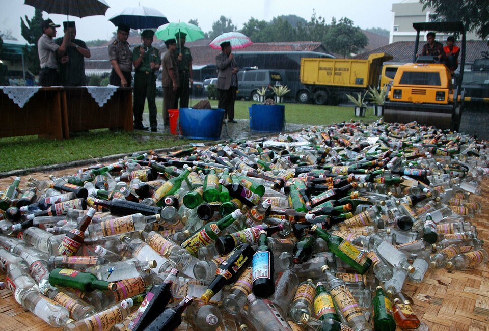 This file photo from 2016 shows the destruction of illegal spirits in Bogor, West Java. The police usually confiscate the beverages from sellers or producers who fail to pay the excises. (Antara Photo/Jafkhairi)