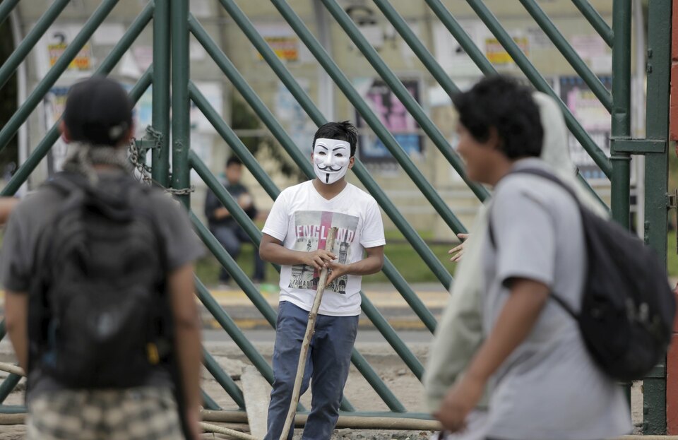 A student wearing a Guy Fawkes mask takes part in a protest to demand a new law that would re-elect a new dean for Peru's University of San Marcos, in Lima on Monday. (Reuters Photo/Janine Costa)