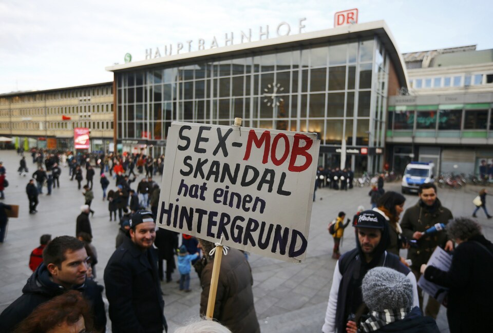 A person holds up a placard reading ‘The sex mob scandal has a background,’ prior to a demonstration by the German anti-Islam movement PEGIDA in front of the main train station in Cologne on Saturday. (Reuters Photo/Wolfgang Rattay)