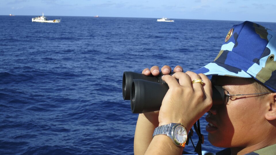 A crewman from the Vietnamese coastguard ship 8003 looks out at sea as Chinese coastguard vessels give chase to Vietnamese ships that came close to the Haiyang Shiyou 981, known in Vietnam as HD-981, oil rig in the South China Sea in this July 15, 2014 file photo.   China's growing military presence in the South China Sea has drawn warnings from the United States that Beijing is seeking to exert control over one of the world's most important sea lanes, but so far the shipping industry seems less concerned.  (Reuters Photo/Martin Petty)