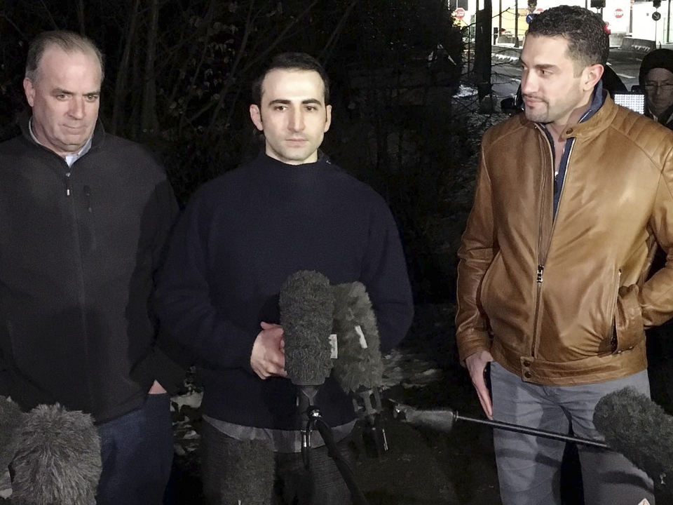 Amir Hekmati (center), flanked by US Congressman Dan Kildee (L) and brother-in-law Ramy Kurdi, speaks with media in Landstuhl, Germany January 19, 2016 for the first time since his release. Hekmati, a former U.S. Marine from Flint, Michigan was released by Tehran with Jason Rezaian and Saeed Adedini and flown to Geneva on Sunday before leaving for Landstuhl military base. (Reuters Photo/Hakan Erdem)