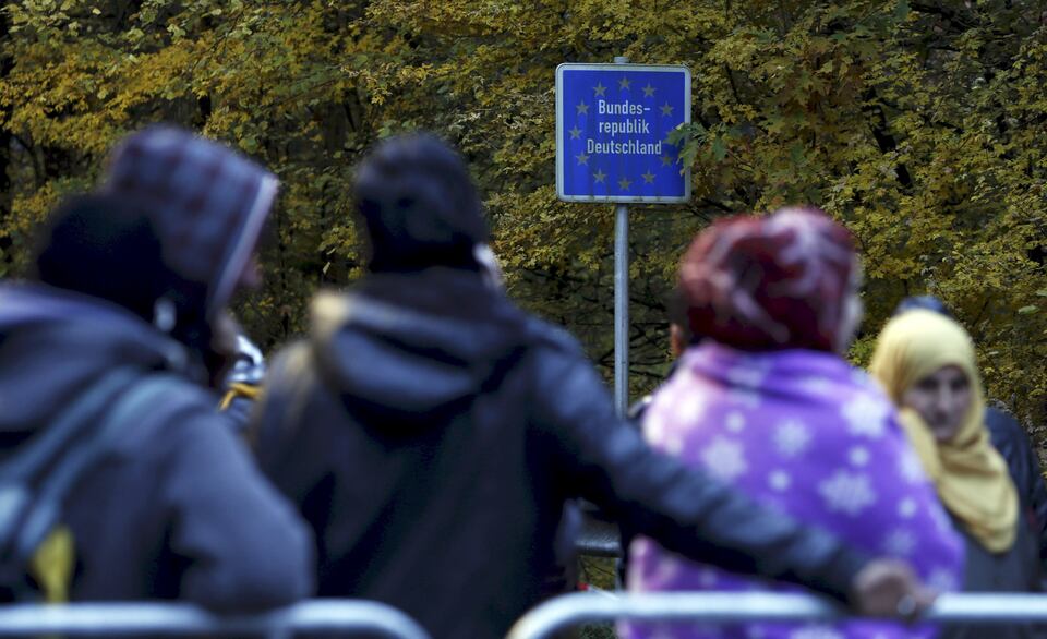 File photo of migrants waiting at the Austrian-German border in Achleiten, Austria, across from Passau, Germany October 29, 2015. In September, the leaders of Austria and Germany took one of the most pivotal decisions of Europe's refugee crisis, throwing open their borders to tens of thousands of migrants piling up in Hungary. Nearly half a year on, however, the display of unity over the Sept. 5-6 weekend is a distant memory. In a sign of how deep Europe's divisions over refugees have become, Berlin and Vienna snipe at each other almost daily. (Reuters Photo/Michaela Rehle)