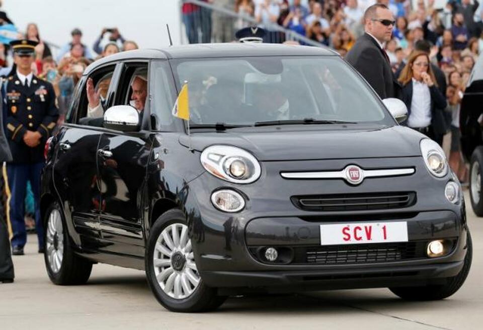 Pope Francis waves as he is driven away in a Fiat 500 model after arriving in the United States at Joint Base Andrews outside Washington in this Sep. 22, 2015 file photo.   (Reuters Photo/Jonathan Ernst/Files)
