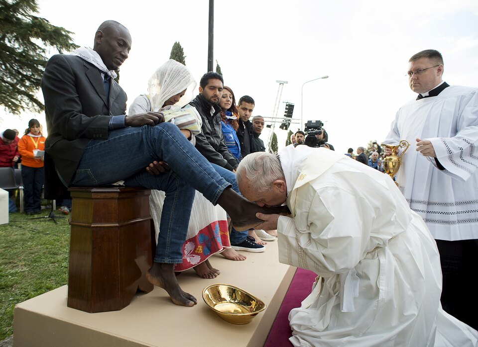 Pope Francis washed and kissed the feet of refugees, including three Muslim men, and condemned arms makers as partly responsible for Islamist militant attacks that killed at least 31 people in Brussels. (Reuters photo/Osservatore Romano)
