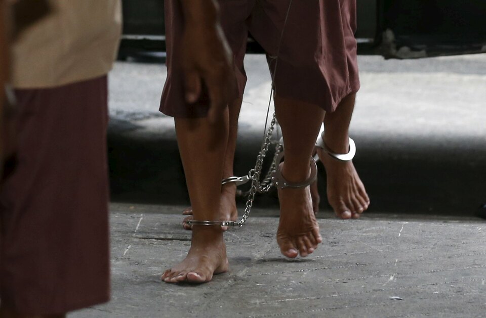 The shackled legs of suspected human traffickers are seen as they arrive for their trial at the criminal court in Bangkok, Thailand.  (Reuters Photo/Chaiwat Subprasom)