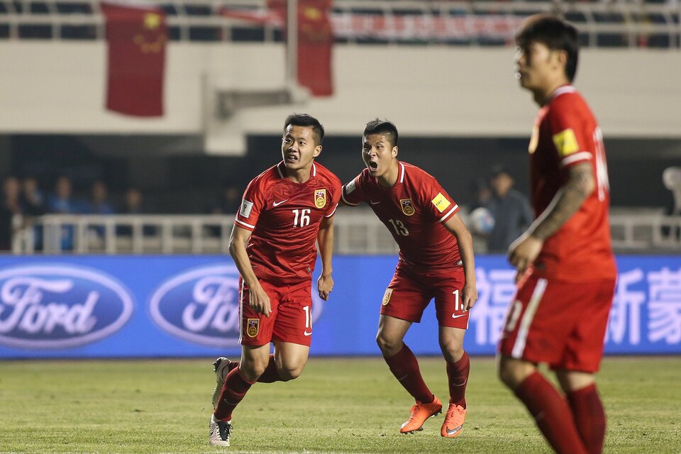Huang Bowen of China reacts after scoring the first goal against Qatar with teammate Zhao Mingjian. (Reuters Photo/Stringer)