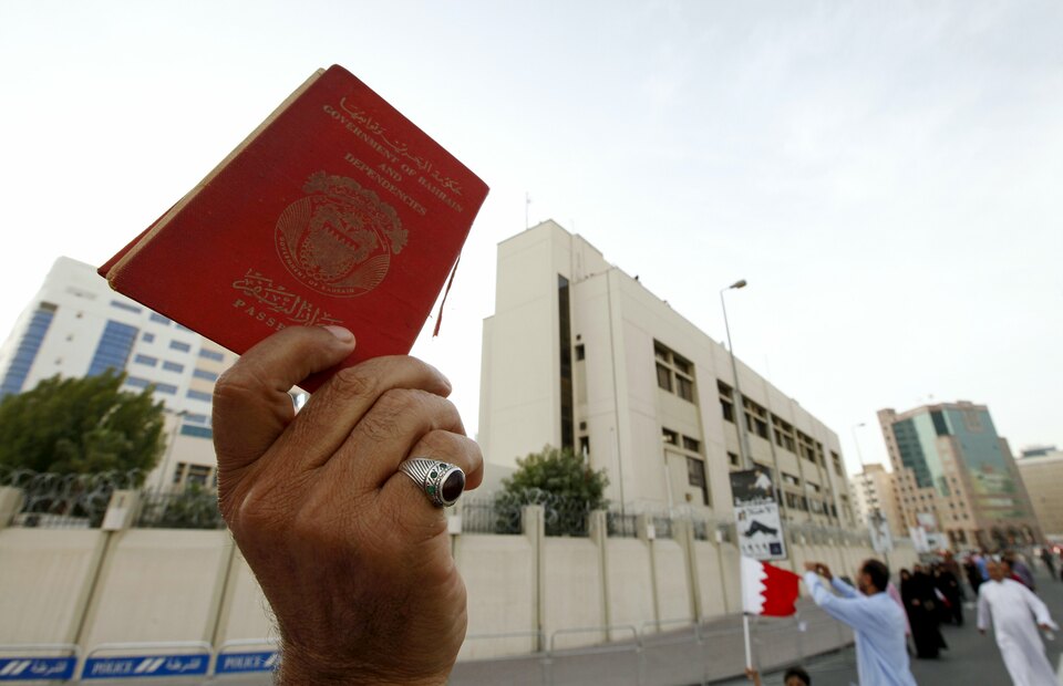 An anti-government protester holds up a Bahraini passport as he protests against nationalization, in front of the Bahrain Immigration Directorate in Manama, in this file picture taken March 9, 2011. (Reuters Photo/Hamad I Mohammed)
