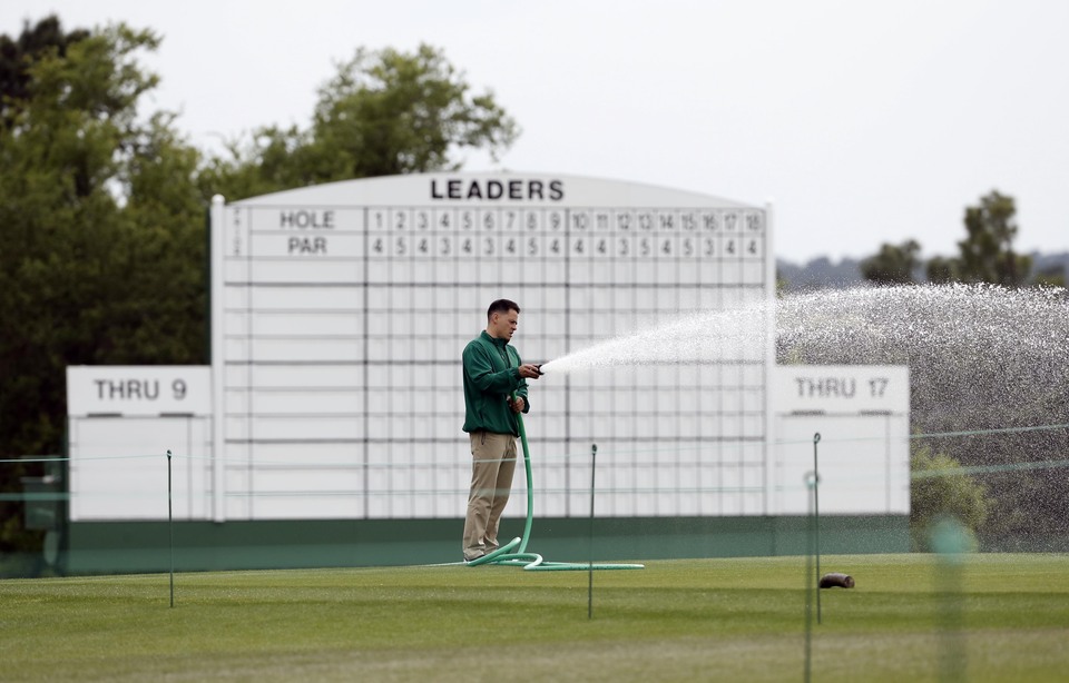 A worker waters the 18th green during a practice round prior to the 2016 The Masters golf tournament at Augusta National Golf Club. (Reuters Photo/Rob Schumacher) 