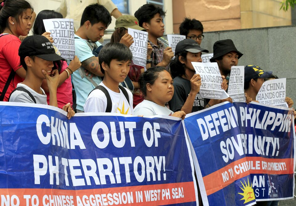 Protesters hold placards and streamers during a rally regarding the disputed islands in the South China Sea, in front of the Chinese Consulate in Makati city in the Philippines in this April 2016 file photo. (Reuters Photo/Romeo Ranoco)
