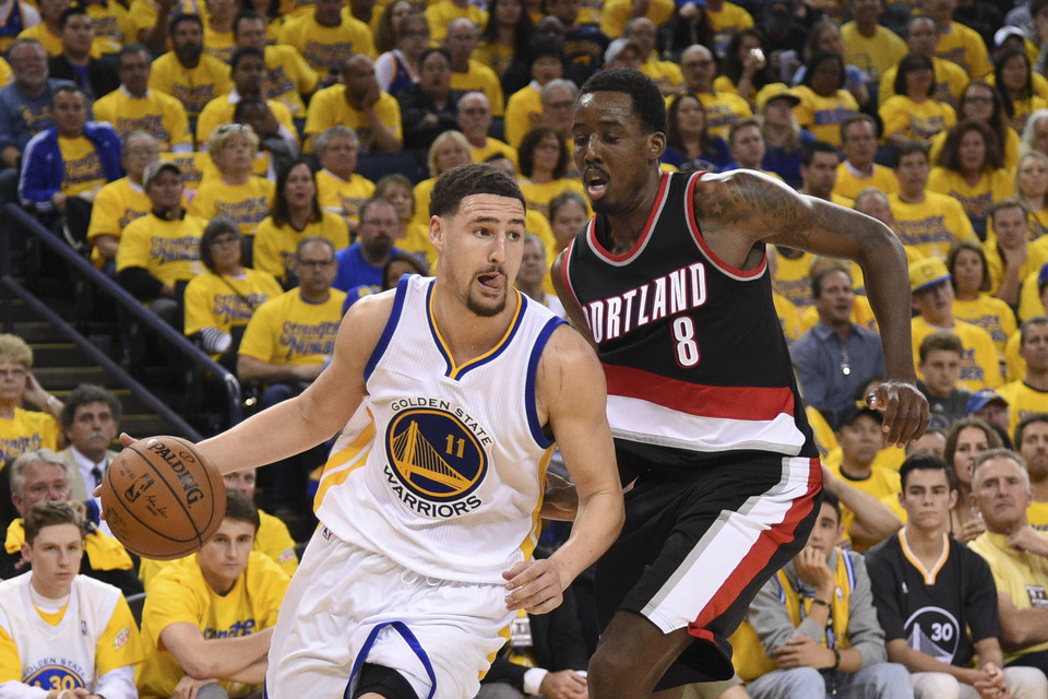 Golden State Warriors guard Klay Thompson (11) dribbles the basketball against Portland Trail Blazers forward Al-Farouq Aminu (8) during the third quarter in game two of the second round of the NBA Playoffs at Oracle Arena. The Warriors defeated the Trail Blazers 110-99. (Reuters Photo/Kyle Terada)