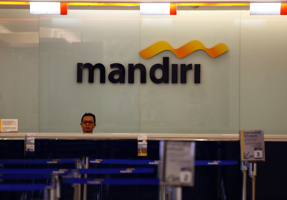 A teller waits for customers at a branch inside Bank Mandiri headquarters in Jakarta in this file photo. (Reuters Photo/Darren Whiteside)