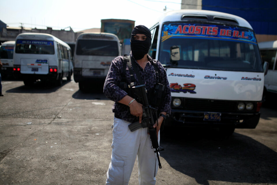 A bodyguard stands outside an office of a bus company in San Salvador, El Salvador. (Reuters Photo/Jose Cabezas)