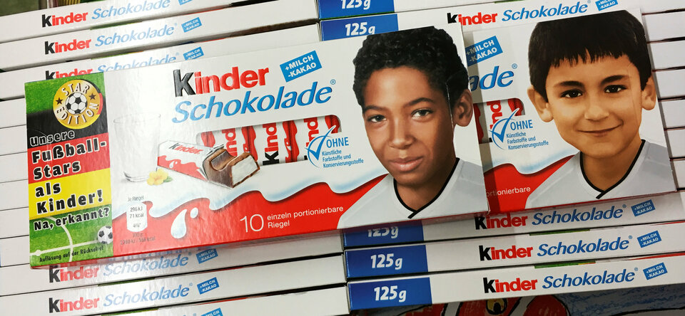 The images of German soccer players Jerome Boateng (L) and Ilkay Guendogan are printed on Ferrero chocolate bar boxes in Berlin, Germany, May 25, 2016.  The text at left reads 'Our soccer stars in childhood. So, recognized?'  (Reuters Photo/Hannibal Hanschke)