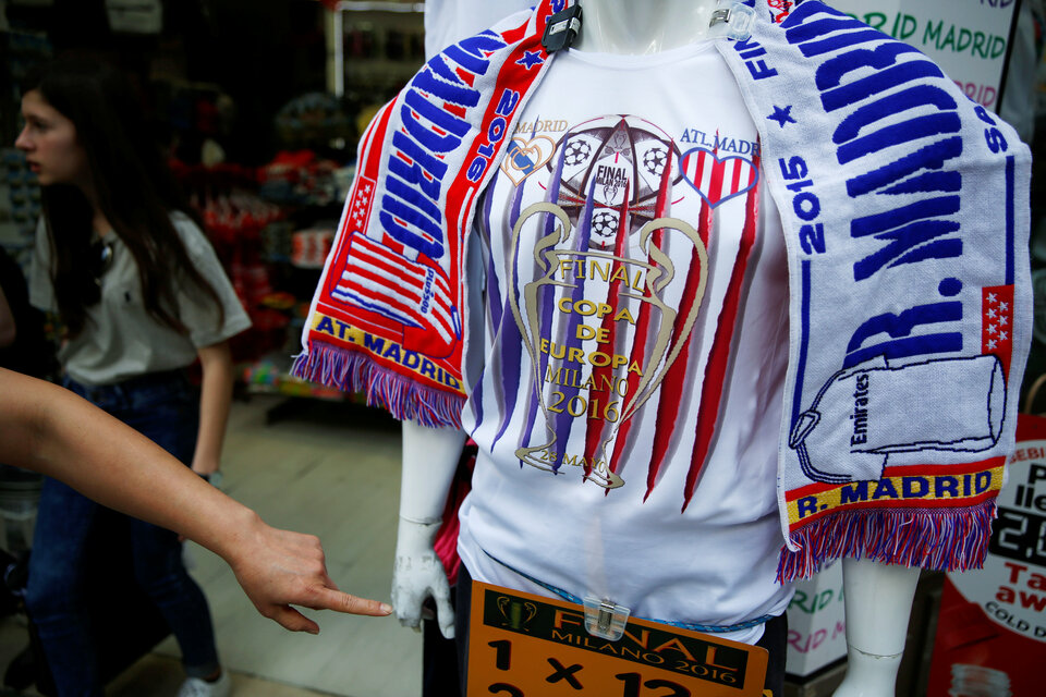 A woman points at a souvenir t-shirt of the UEFA Champions League Final between Atletico Madrid and Real Madrid at a souvenir store in downtown Madrid, Spain. (Reuters Photo/Susana Vera)