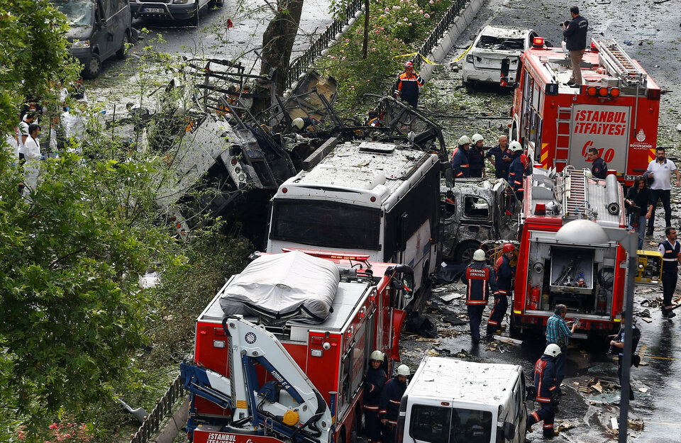 Forensic experts and firefighters stand beside a Turkish police bus, which was targeted in a bomb attack in a central Istanbul district, Turkey, on June 7. (Reuters Photo/Osman Orsal)