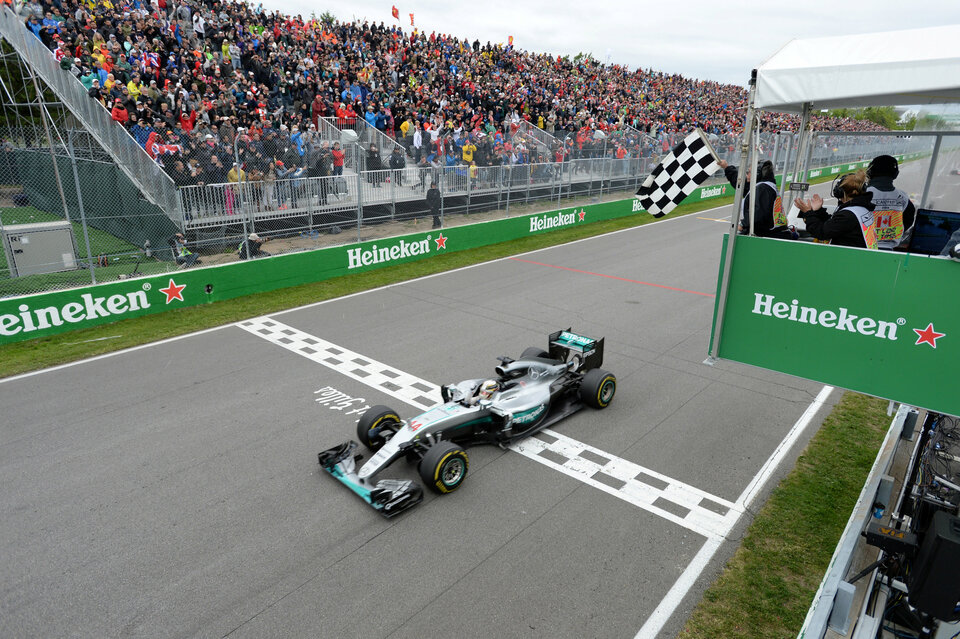 Mercedes F1 driver Lewis Hamilton of Britain crosses the finish line to win. (Reuters Photo/Paul Chiasson)