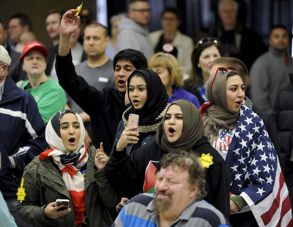 Young Muslims protest against US Republican presidential candidate Donald Trump before being escorted out during a campaign rally in the Kansas Republican Caucus at the Century II Convention and Entertainment Center in Wichita, Kansas March 5, 2016. (Reuters Photo/Dave Kaup)