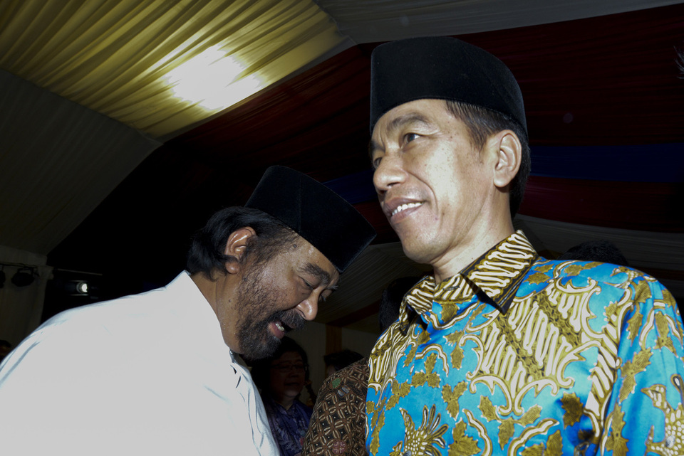 President Joko 'Jokowi' Widodo and National Democratic Party (NasDem) chairman Surya Paloh during a fast-breaking event, or iftar, at the party's headquarters in Jakarta on Tuesday (07/06). The theme of the event was 'Fasting and Pancasila: A Spirit of Brotherhood and Solidarity for Social Justice.' (Antara Photo/Rosa Panggabean)