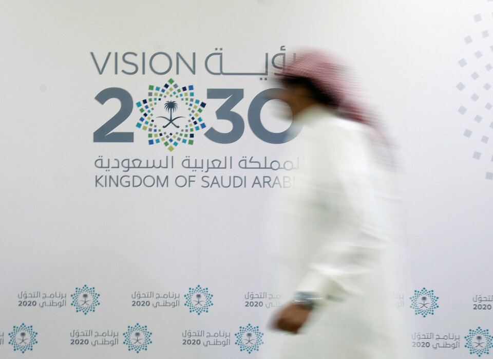 A man walks past the logo of Vision 2030 after a news conference, in Jeddah, Saudi Arabia. (Reuters Photo/Faisal Al Nasser)