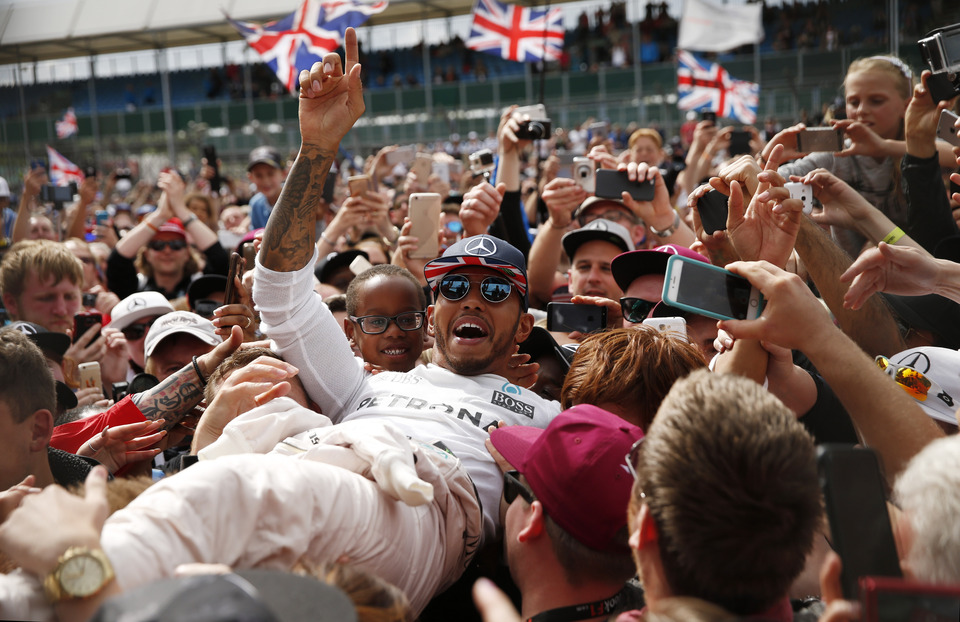 Mercedes' Lewis Hamilton celebrates with fans after winning the race in the British Grand Prix 2016. (Reuters Photo/Andrew Boyers)